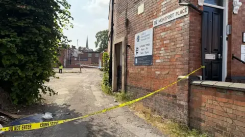 Police tape cordoning off De Montfort Place in Leicester