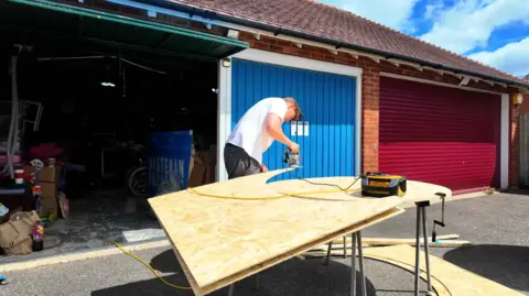 A man cutting wood. 