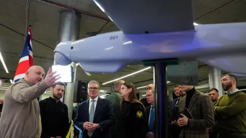 PA Media Prime Minister Sir Keir Starmer (centre) and Ukrainian President Volodymyr Zelensky (2nd left) attend a presentation of Ukrainian military drones at an undisclosed location, during his visit to Ukraine to sign a new long-term partnership deal with Volodymyr Zelensky. 