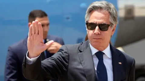 Reuters Antony Blinken waves upon his arrival at Cairo airport
