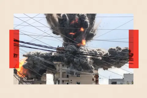 AFP via Getty Images A fireball rises from a building hit by an Israeli airstrike in the area of Abbasiyeh, on the outskirts of the southern Lebanese city of Tyr 