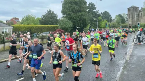 Pacemaker Several runners on east Belfast's Beersbridge Road last year