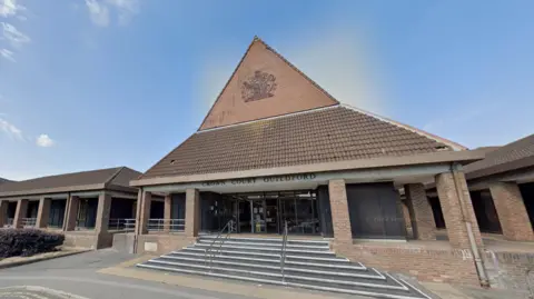 Guildford Crown Court building, a red brick building with a triangular entrance