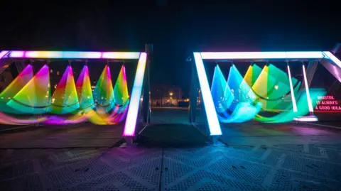 Bristol Light Festival The movement of lit up swings is creating an interesting effect on the photograph, leaving traces of where the light has moved. 