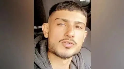 West Mercia Police Aurman Singh, wearing a beard and brown hoody and coat