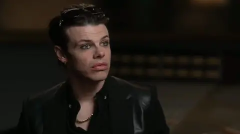 Yungblud looks at the camera with a serious expression 