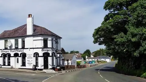 The road which curves around, you can see the pub which reads Ginger Hall.