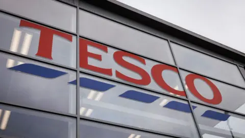 A close-up view of the Tesco logo on the front of a store