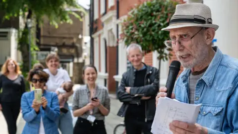 Getty Images Michael Rosen addresses the crowd at a former strike rally at the university in 2024