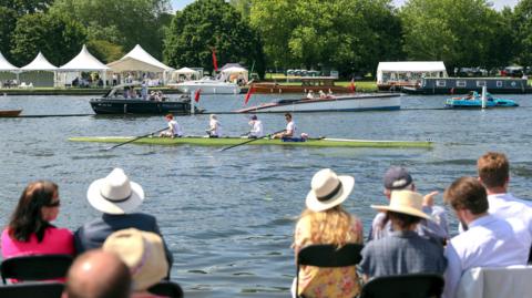 Spectators watching boats on the River Thamess taking part in the Henley Regatta 2019