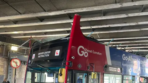 Bus with its roof ripped off