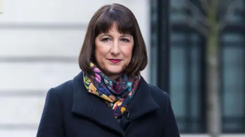 Getty Images Chancellor Rachel Reeves outside wearing a coat and scarf