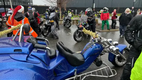 A general view of a large blue, three-wheeled motorcycle.