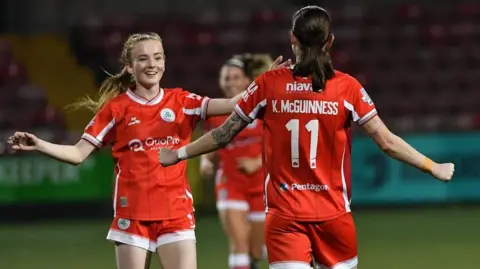 Cliftonville's Caitlin and Kirsty McGuinness celebrate 