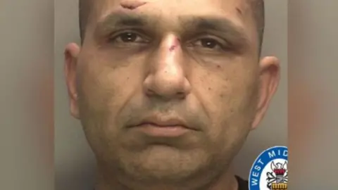 Mohammed Shaheeb, seen in a police mugshot. He is clean-shaven and has various cuts on his face.