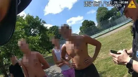 Two police officers dispersing a group of teenagers in Herne Bay.