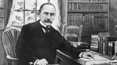 English novelist, poet and dramatist, Thomas Hardy in his study at his Dorchester home. 