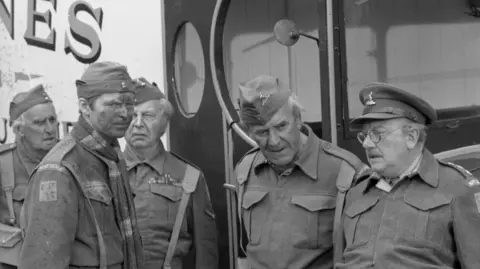Five characters from Dad's Army standing next to Jones's butcher's van