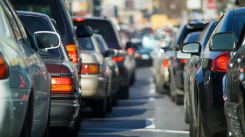 Row of cars bumper to bumper on road