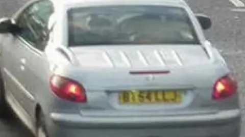 Warwickshire Police A grainy image of the rear of a silver car