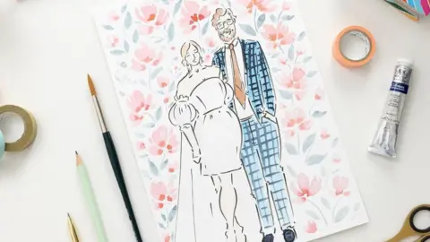 A promotional picture of one of Helen Ridley's sketches: a bride and groom at their wedding painted in a colourful watercolour style with pens, scissors and tape pictured around the paper.