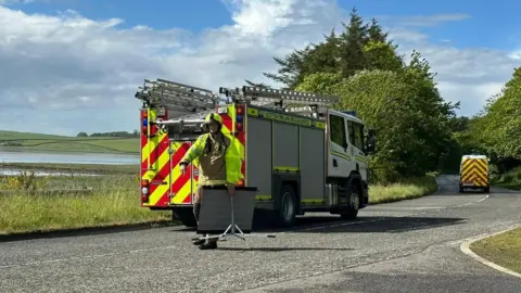 BBC A fire engine parked at the side of the road near Newburgh in Aberdeenshire while responding to a fire at a dwelling caused by a lightning strike.