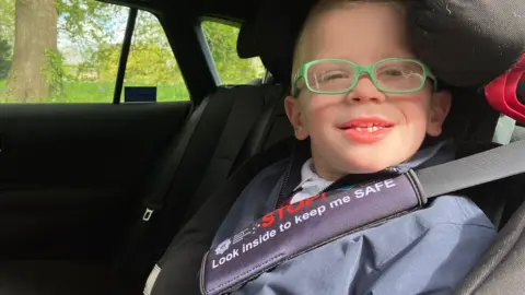 Five-year-old Albert Birchley with his seat belt cover