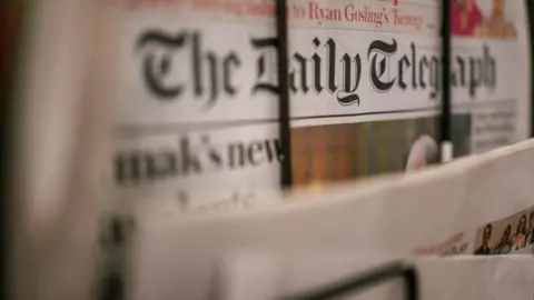 Daily Telegraph paper on a stand