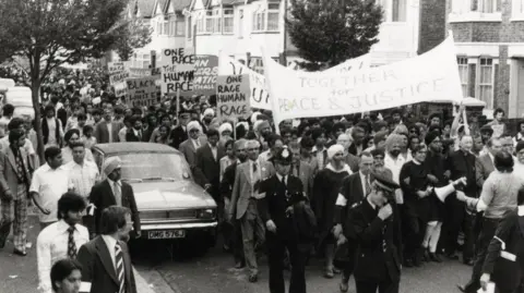 A black and white photograph of an anti-racism demonstration in Coventry.