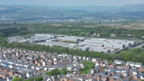 An aerial shot of HMP Parc with residential houses seen in front of it.
