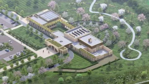 Artist's aerial impression  of the crematorium, showing a central mainly single storey building in light stone, with a chimney above one section. An entrance is visible, opening out onto a paved square area. There are tree-lined pathways surrounding the building.