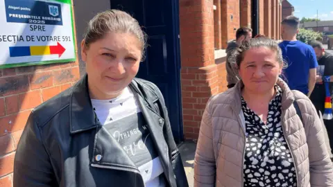 BBC/Olimpia Zagnat Two women stand outside a polling station in the UK