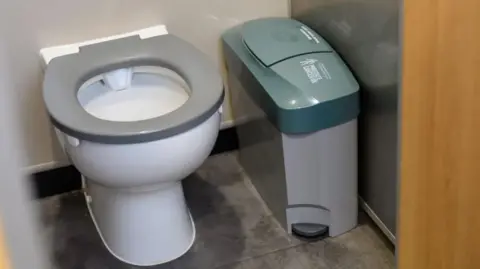 GTR A toilet cubicle with a mens sanitary bin 