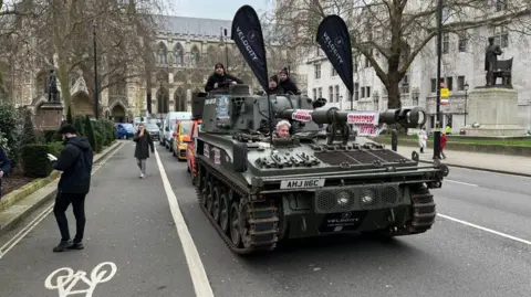 A tank riding towards camera along Whitehall in London 