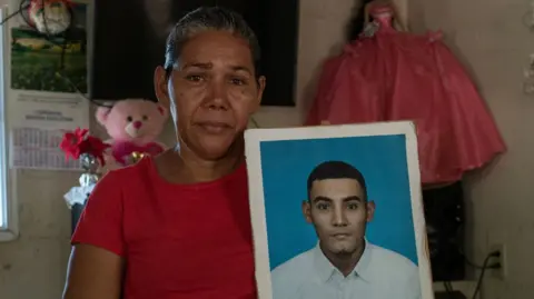 Marcela Alvarado holds up a picture of her son José Duval Mata