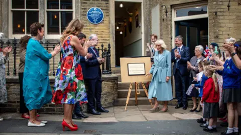 Queen Camilla leaves the Brontë house to a round of applause.