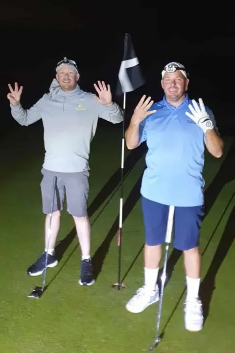 Nicolas Brewaeys Two men playing golf in the dark