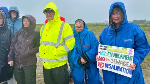 Protesters in wet weather gear