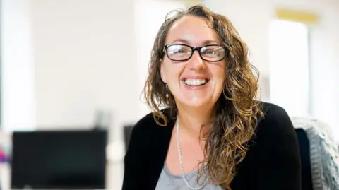 Catapult Energy Systems Jo Atkinson looks happy sitting at her desk