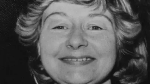 Bedfordshire Police Carol Morgan: a black and white image of the face of a smiling woman