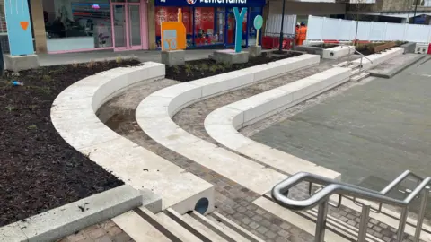 Seating surrounding a large paved area in Yeovil town centre.