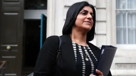 EPA Shabana Mahmood walks along Downing St holding a folder