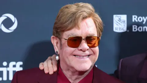 Getty Images Elton John astatine  the reddish  carpet of his premiere for his documentary successful  Toronto 