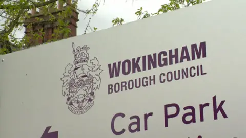 BBC A white sign bears the words "Wokingham Borough Council" above the words "car park"