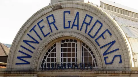 Steve Daniels/Geograph Semi circular tiled sign saying Winter Gardens in blue on cream on the outside of the building