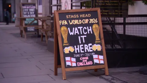 Sign outside a pub reading 'Fifa World Cup 2026 Watch It Here Come on England'
