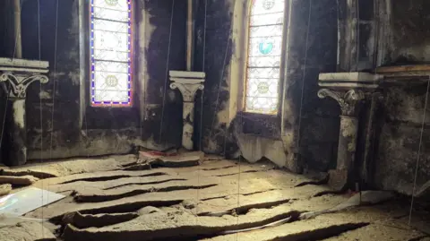 Mike Morrison/Paignton Community Steam A general view of inside the monastery. It is extremely dirty, and the floor is uneven. The walls appear to be damaged. 