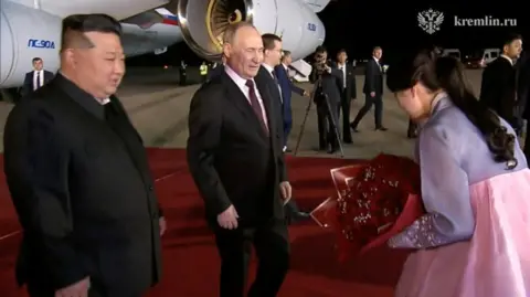 Reuters Mr Putin presented with flowers on arrival