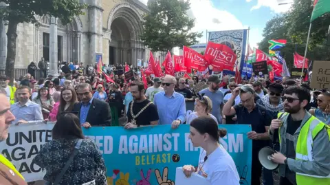 Campaigners at Writer's Square holding banners and flags