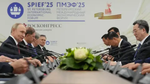 EPA Russian President Vladimir Putin (L) speaks with Chinese Vice Premier Ding Xuexiang (R) during their meeting on the sidelines of the St. Petersburg International Economic Forum in St. Petersburg, Russia